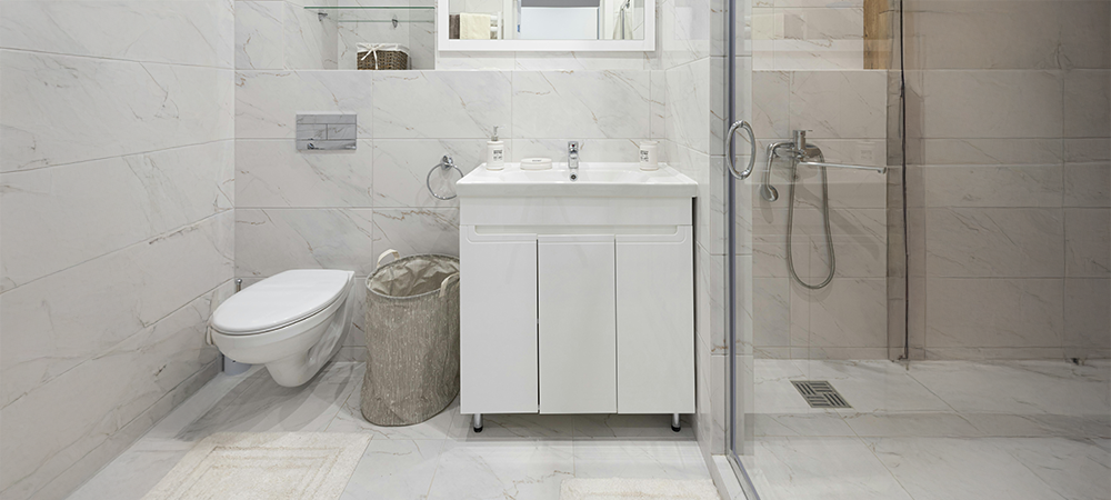 Compact white bathroom vanity with laundry basket Compact white bathroom vanity with laundry basket