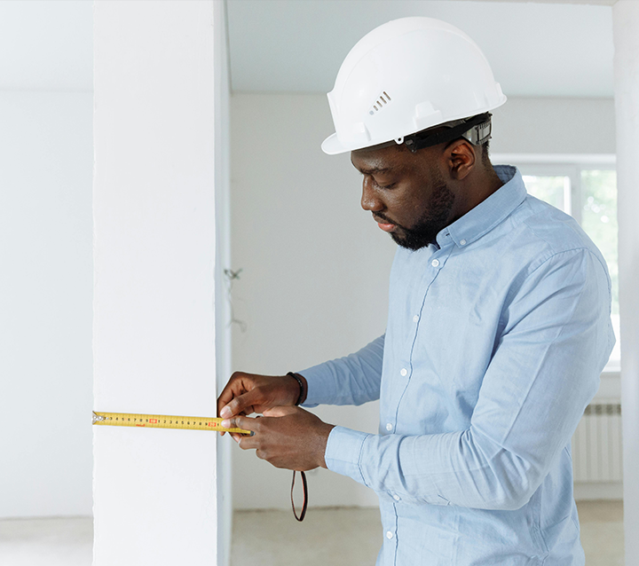 Contractor measuring kitchen space for cabinet installation Contractor measuring kitchen space for cabinet installation