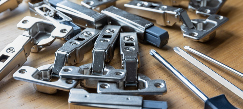 Technician adjusting soft-close cabinet hinges