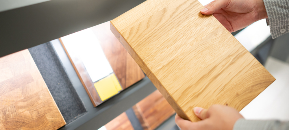 Hand selecting different cabinet panel materials for kitchen renovation