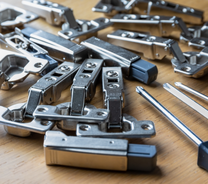 Technician adjusting soft-close cabinet hinges