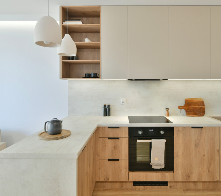 Two-Tone Kitchen with Wood Accents Modern kitchen with light gray cabinets and wood accents, creating a warm and inviting atmosphere.